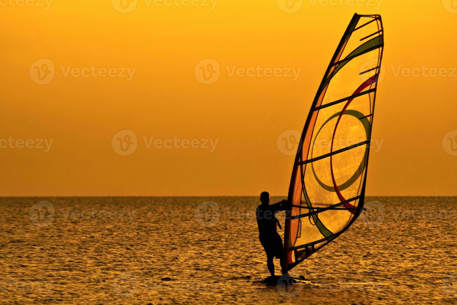 Windsurfer over the sunset photo