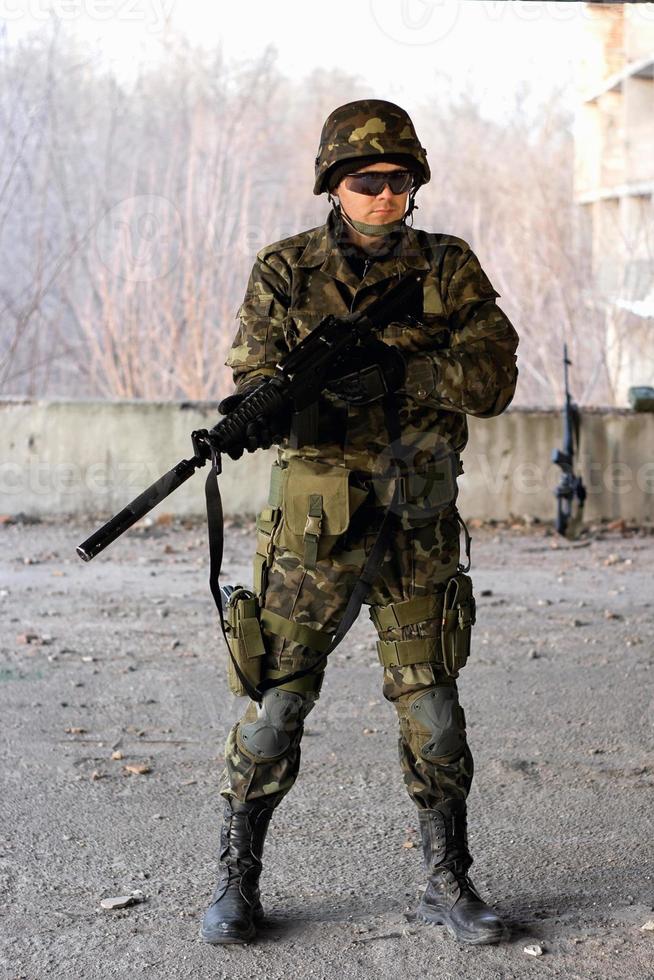 Military guy holding a gun photo