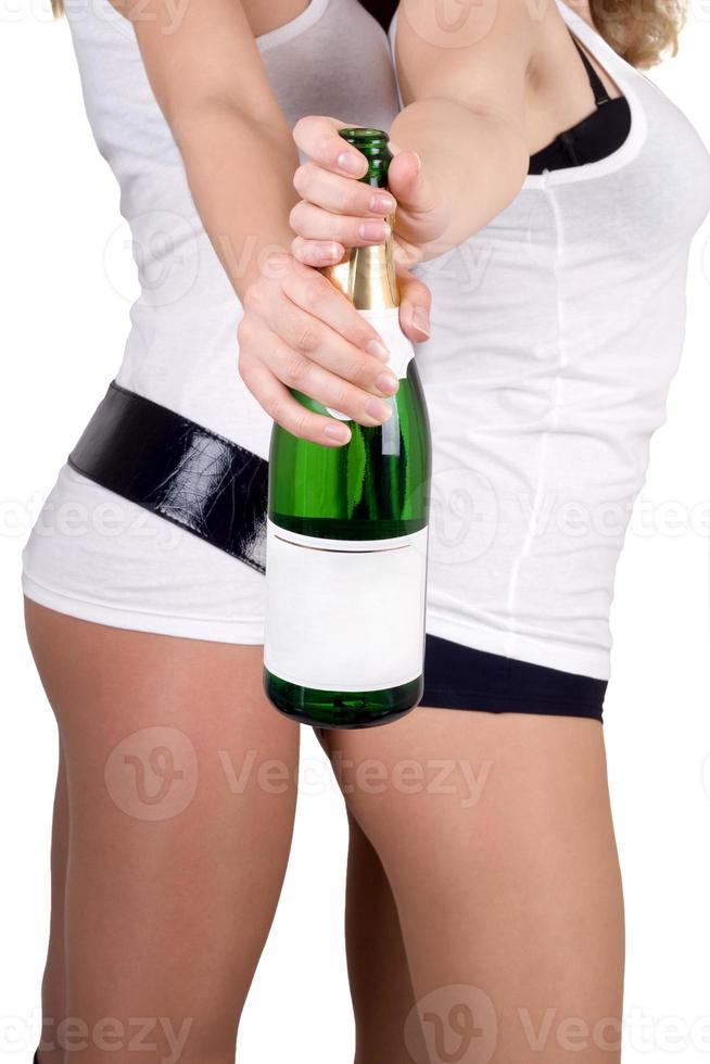 Two girls with a champagne bottle. Isolated photo