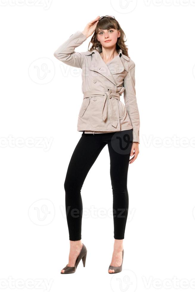 Lovely girl wearing a coat and black leggings. Isolated photo