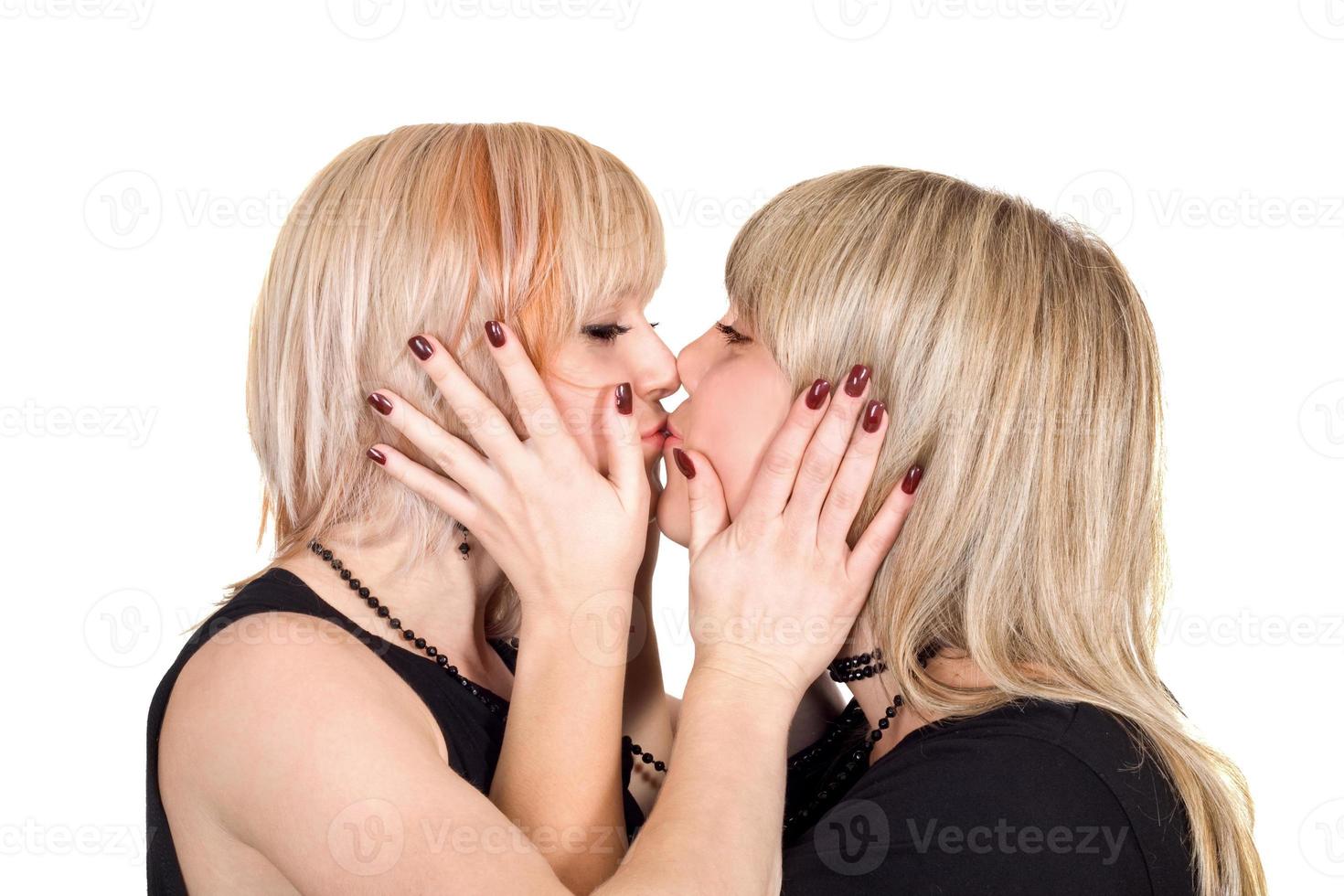 Two young beauty kissing blonde. Isolated on a white photo