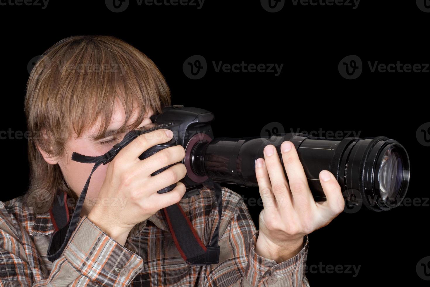 Photographer with the camera with a zoom lens photo