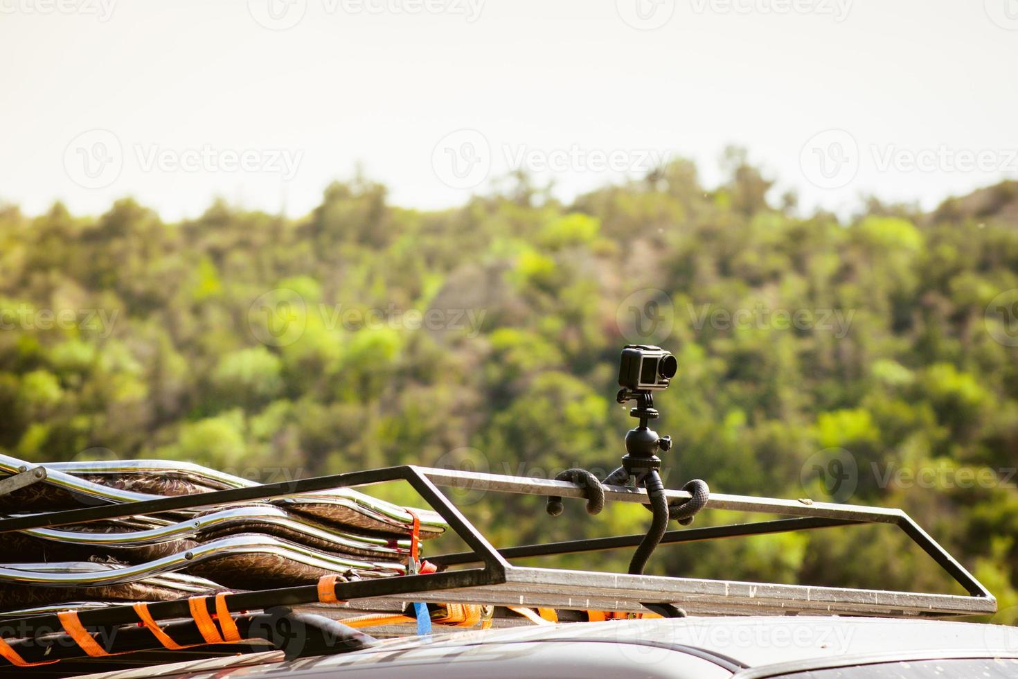 Action sports camera on rooftop attached with gorilla tripod ready documenting adventure on safari tour outdoors. Shooting and filming travels. Hyperlapse timelapse shooting photo