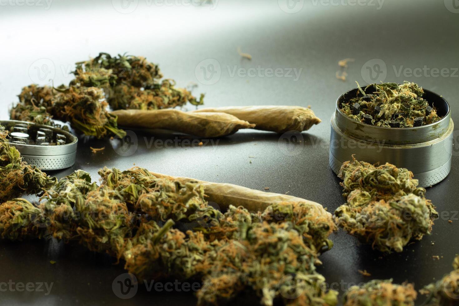 Cone rolled joints on desk, cannabis buds, marijuana weed in grinder