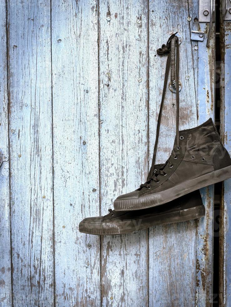 a black pair of worn men's textile sneakers photo