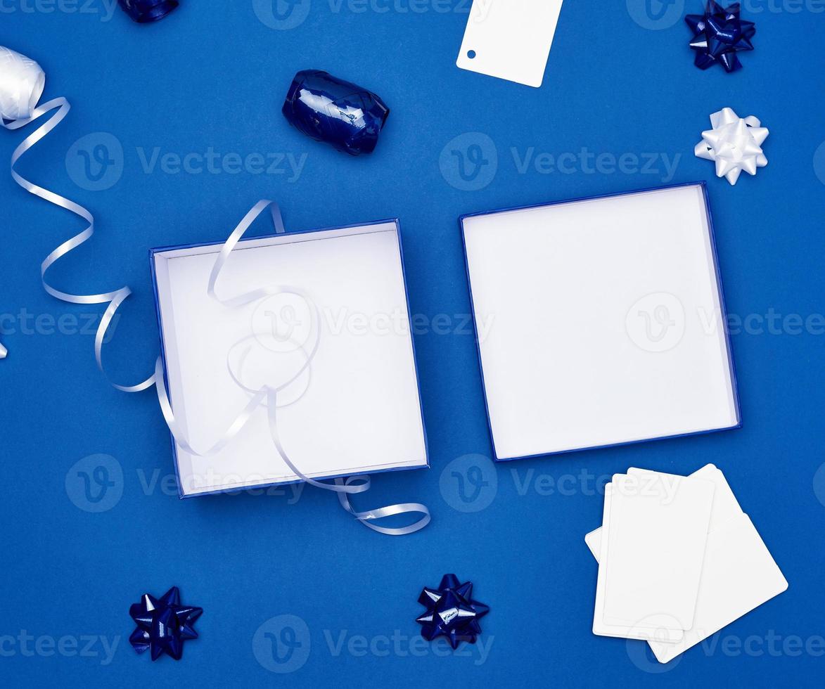 open cardboard gift square boxes, bows, ribbons for packaging photo