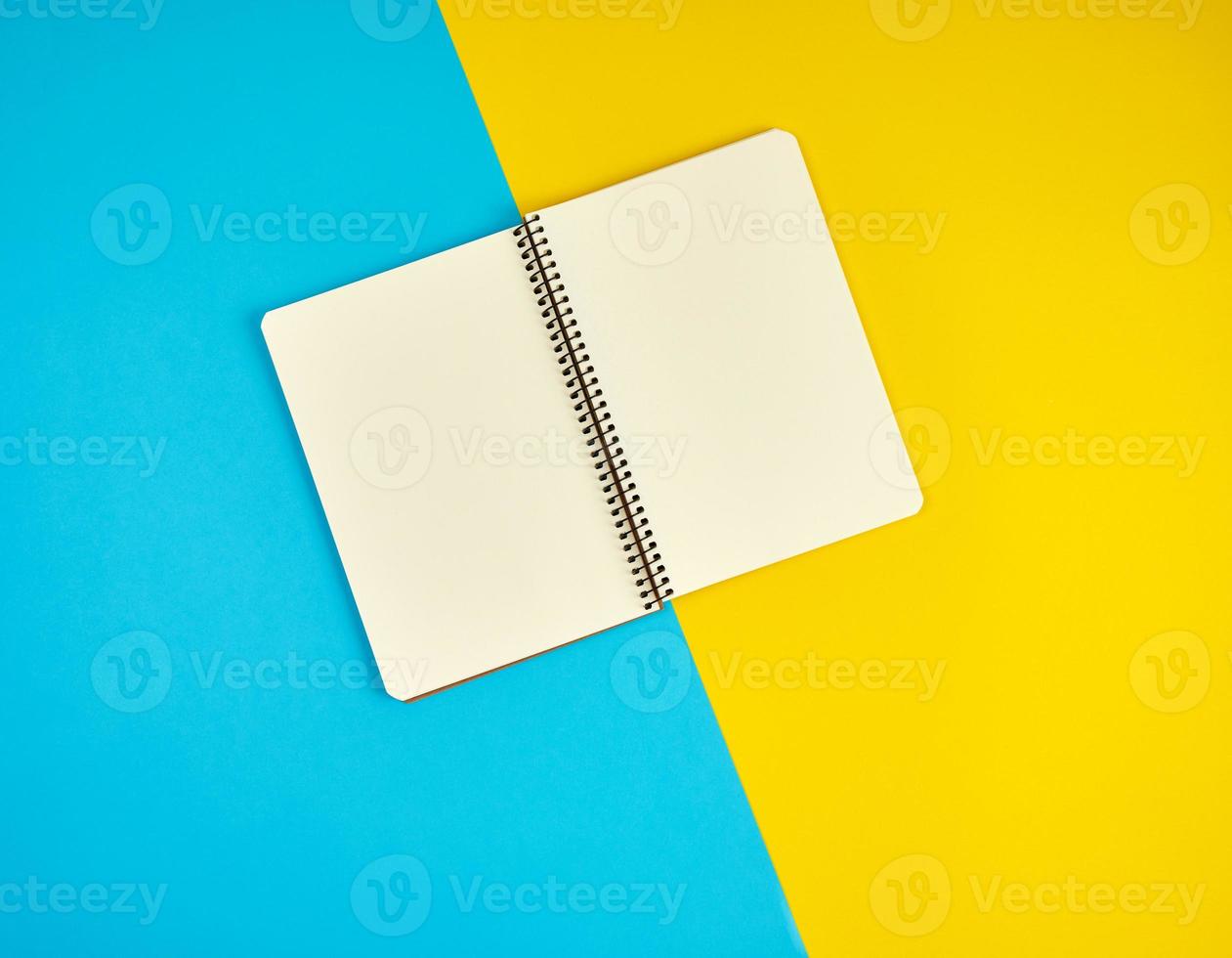 open spiral notebook with blank white pages photo