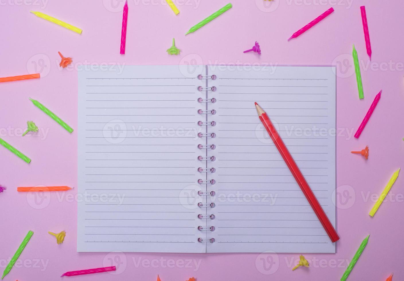 notebook in line and red wooden pencil photo