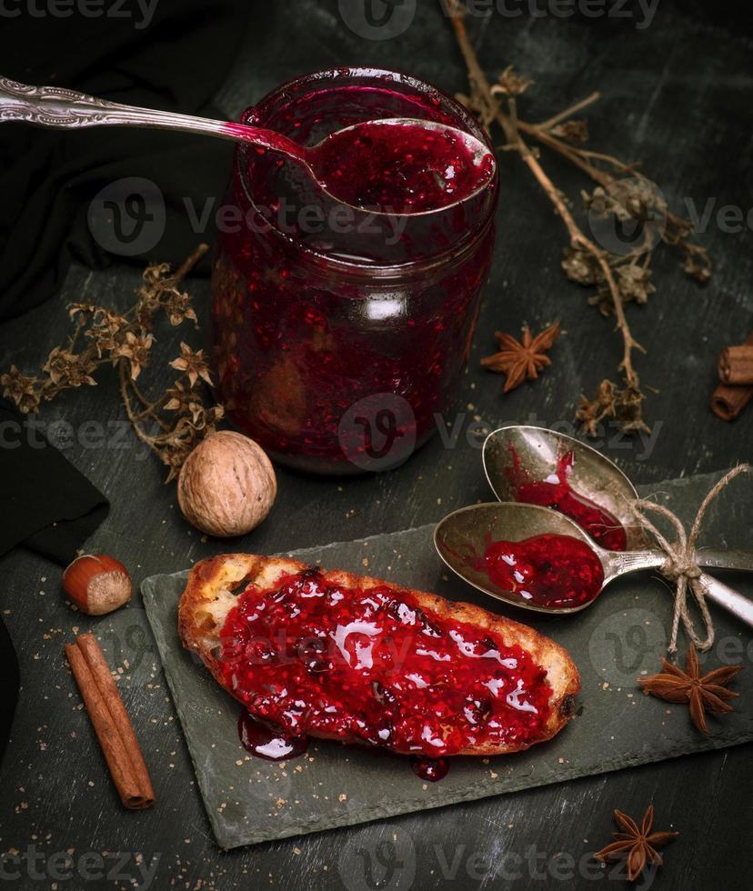 toast with raspberry jam and empty jam jar photo
