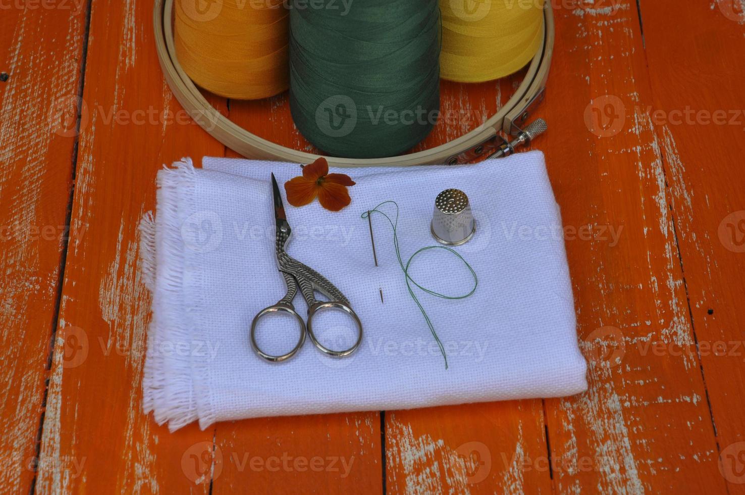 variety of objects for needlework orange on the wooden table photo