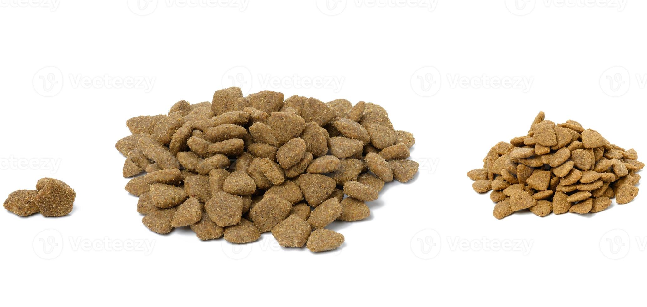 triangular pieces of animal food on a white background. Pile of nutritious food photo
