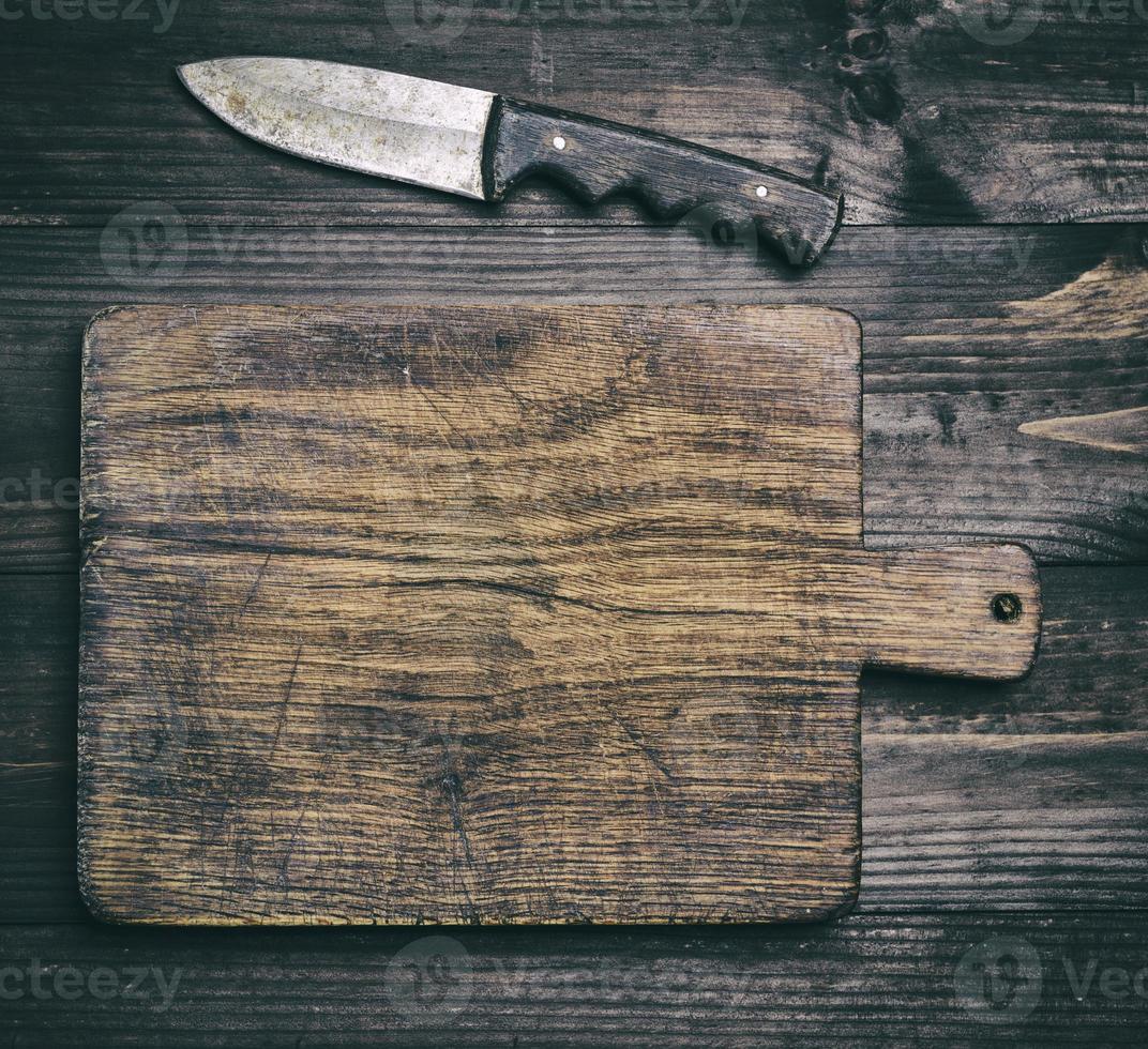 very old wooden brown cutting board and knife photo