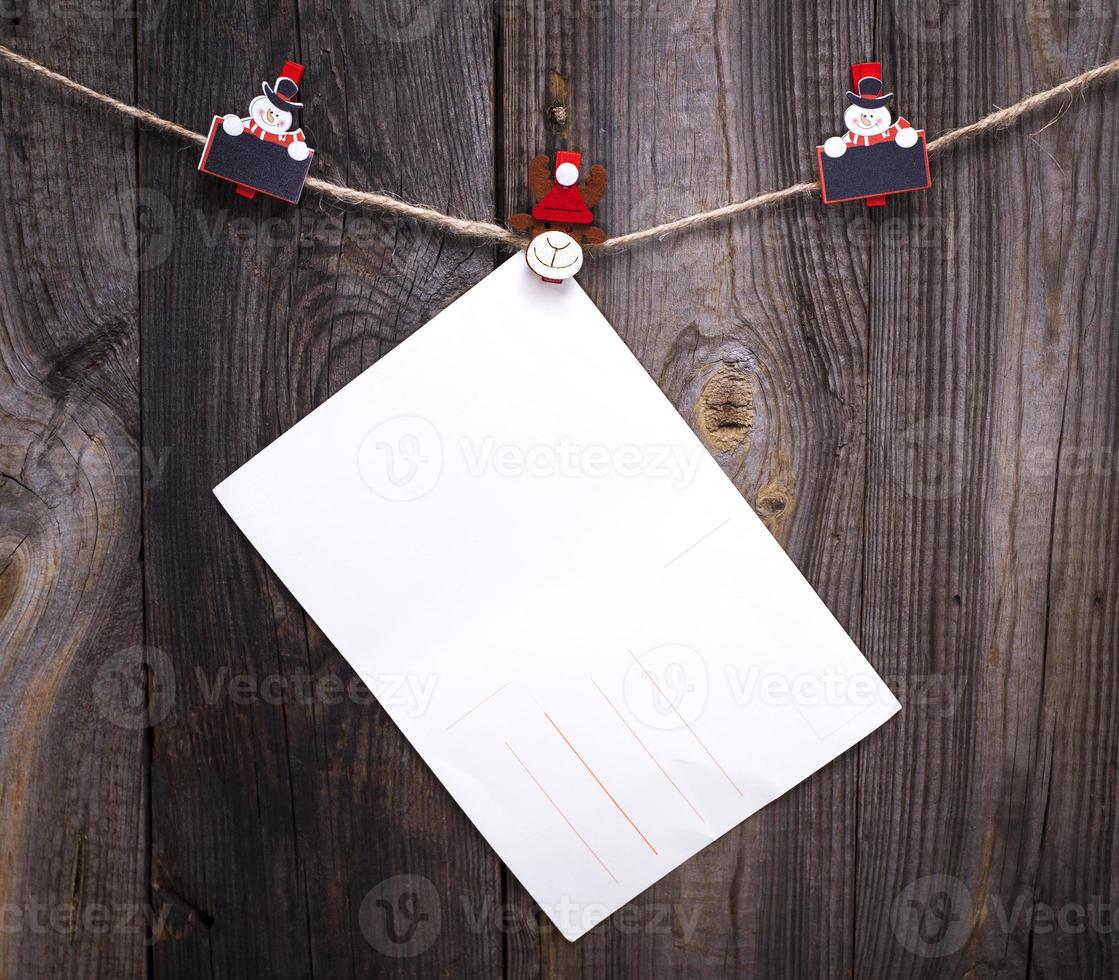 empty white paper post hanging on a rope photo