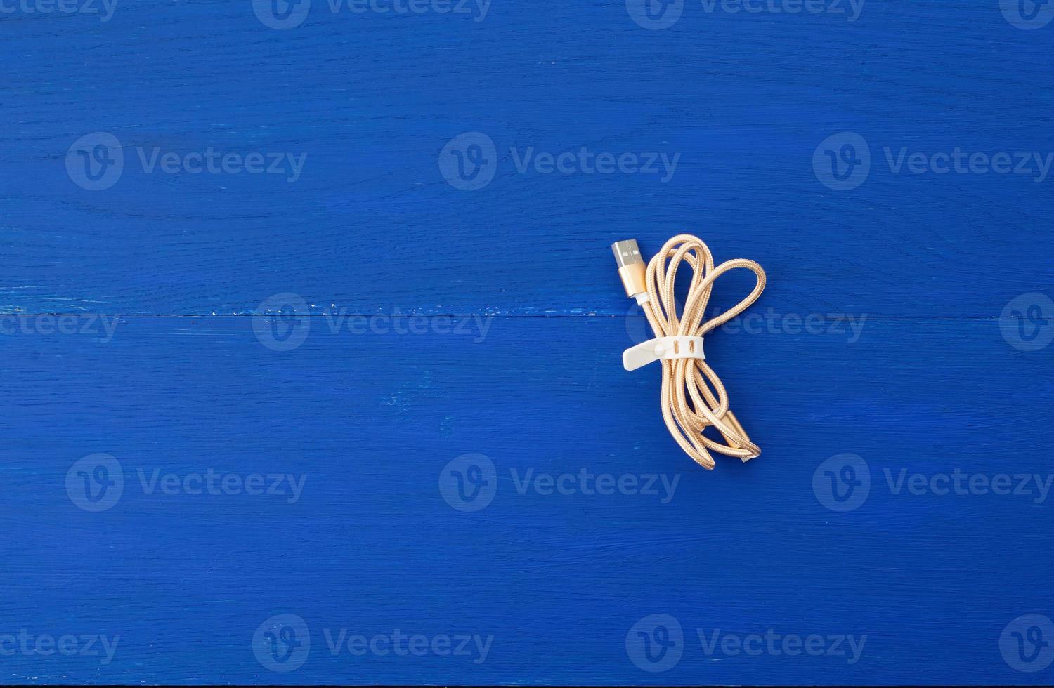 twisted golden cable for charging with electricity equipment in textile winding photo