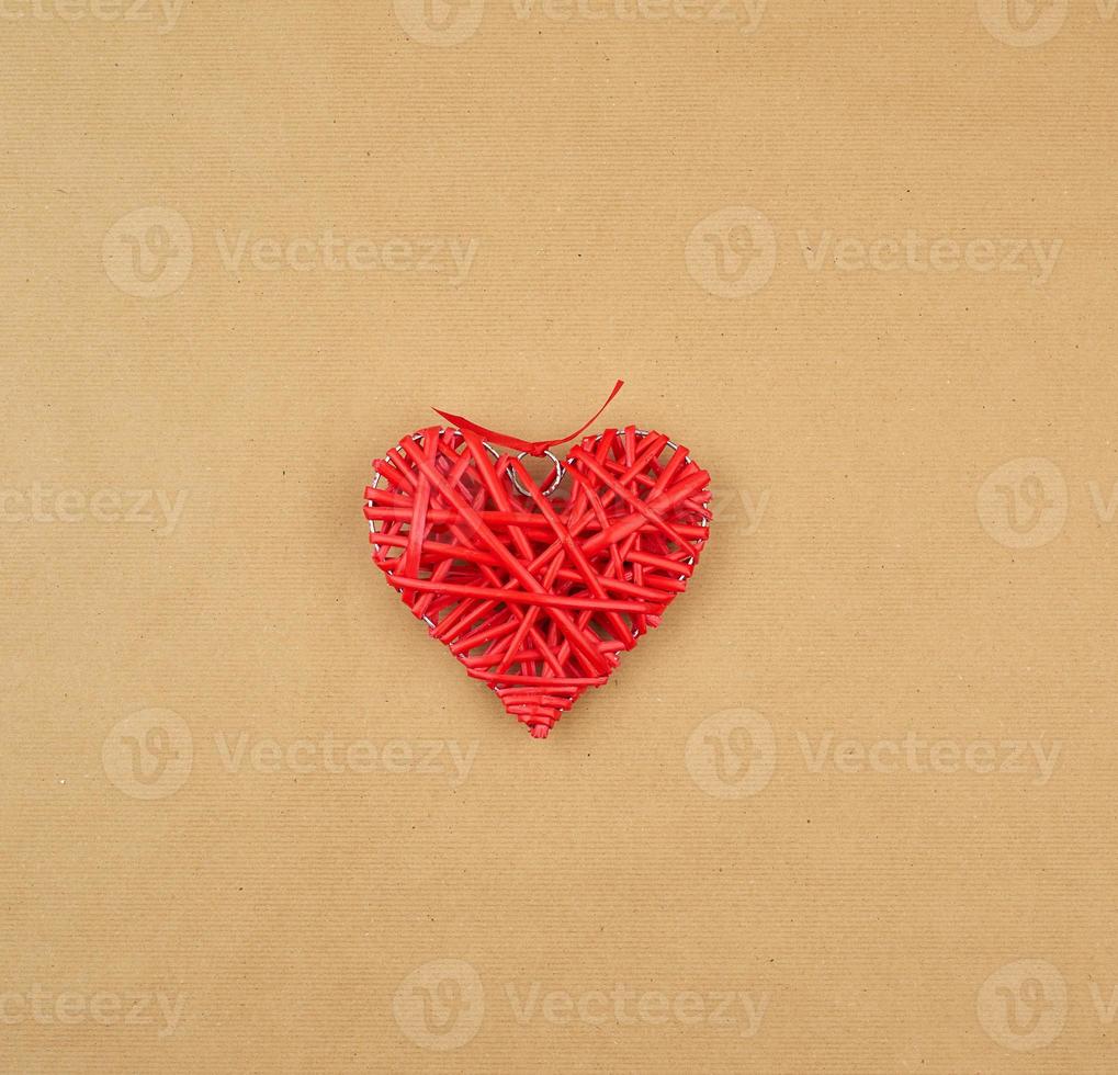 red wicker decorative heart on a brown paper photo