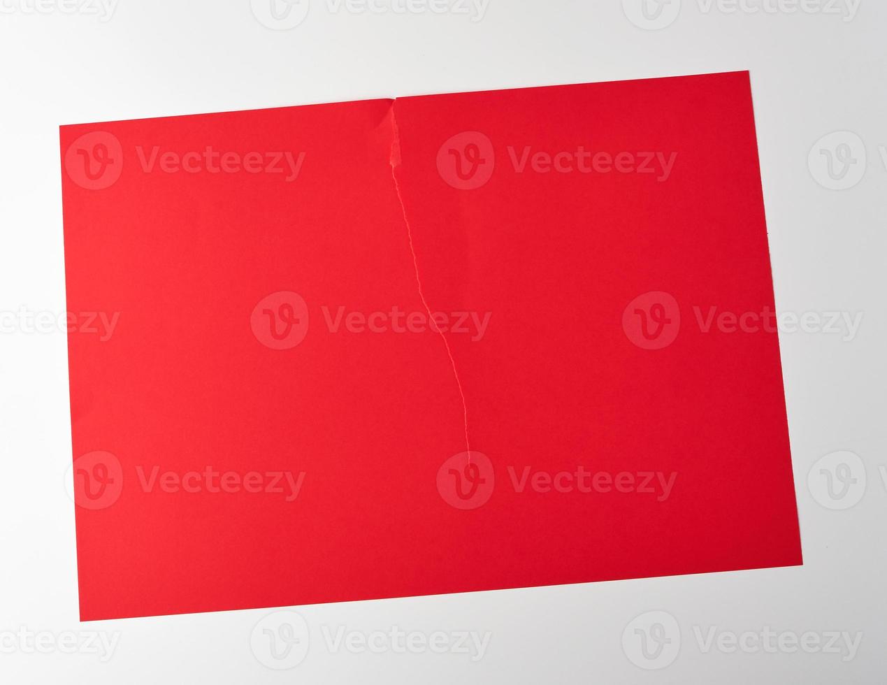 torn in half empty red sheet of paper on white background photo