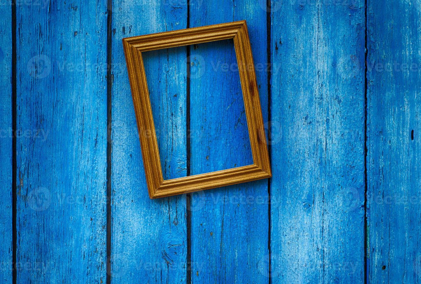 Empty wooden frame on the blue wall photo