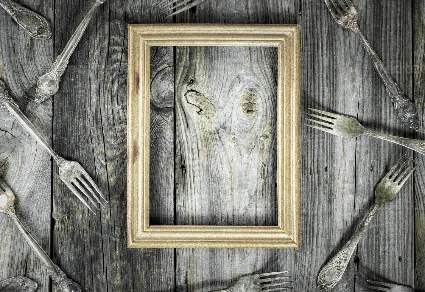 empty wooden frame on a gray wooden surface photo
