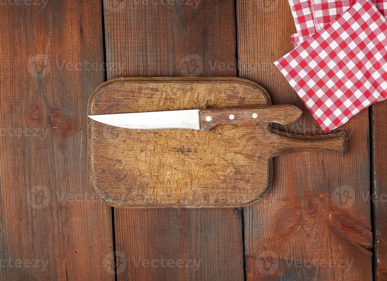 very old empty wooden rectangular cutting board and knife photo