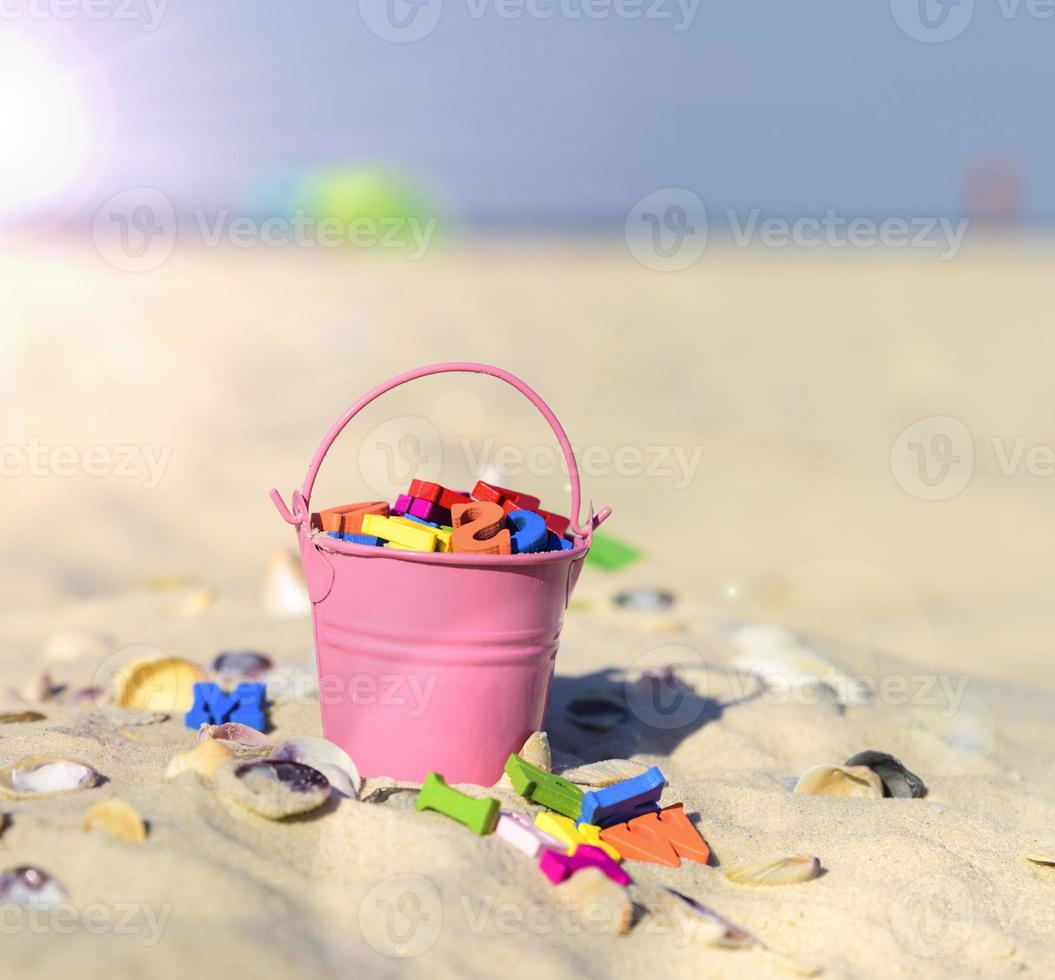 pink baby iron bucket filled with wooden colorful letters photo