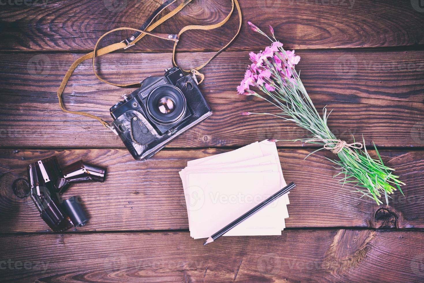 Blank greeting card and old vintage film camera photo