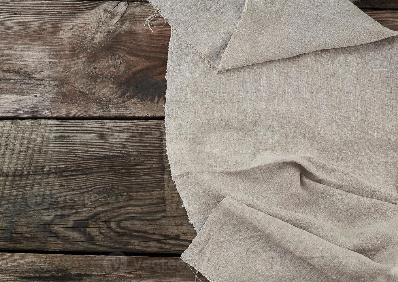 servilleta de lino gris fondo de madera de cocina en estilo vintage foto