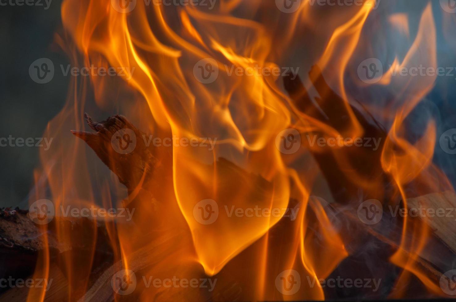 burning fire in a brick fireplace close up photo