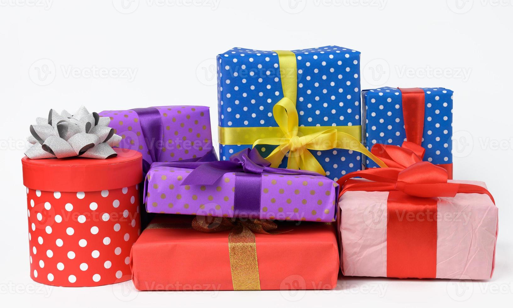 stack of boxes wrapped in paper and tied with a silk ribbon on a white background, celebration. photo