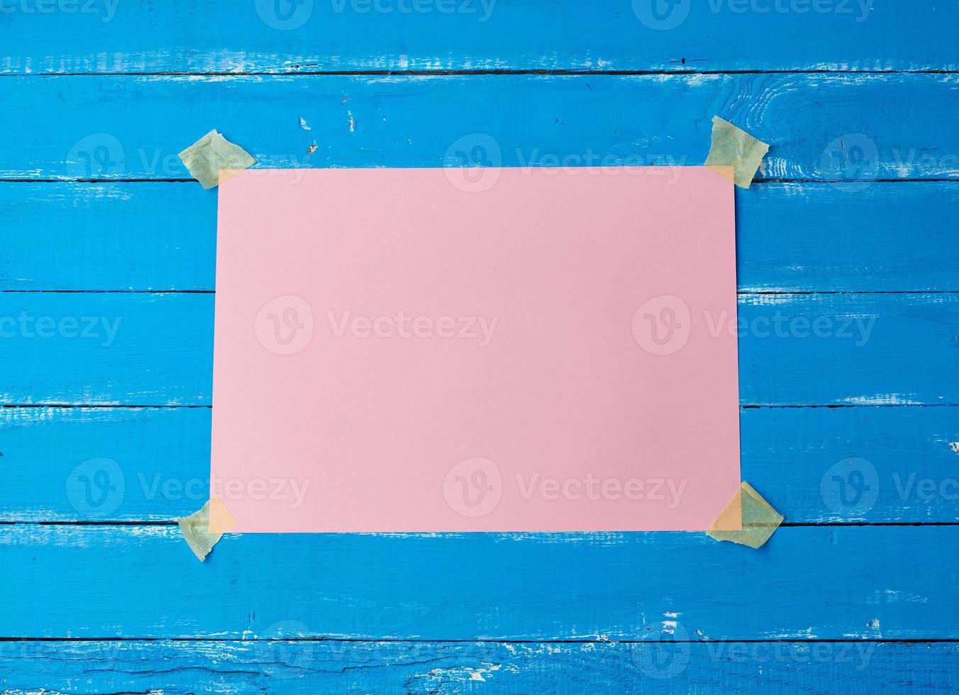 glued with adhesive tape a rectangular empty pink sheet of paper photo