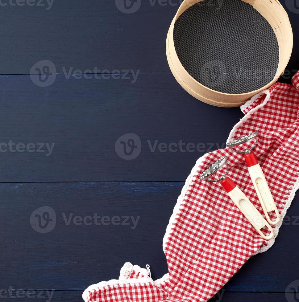 round flour sieve on a blue wooden background, top view photo