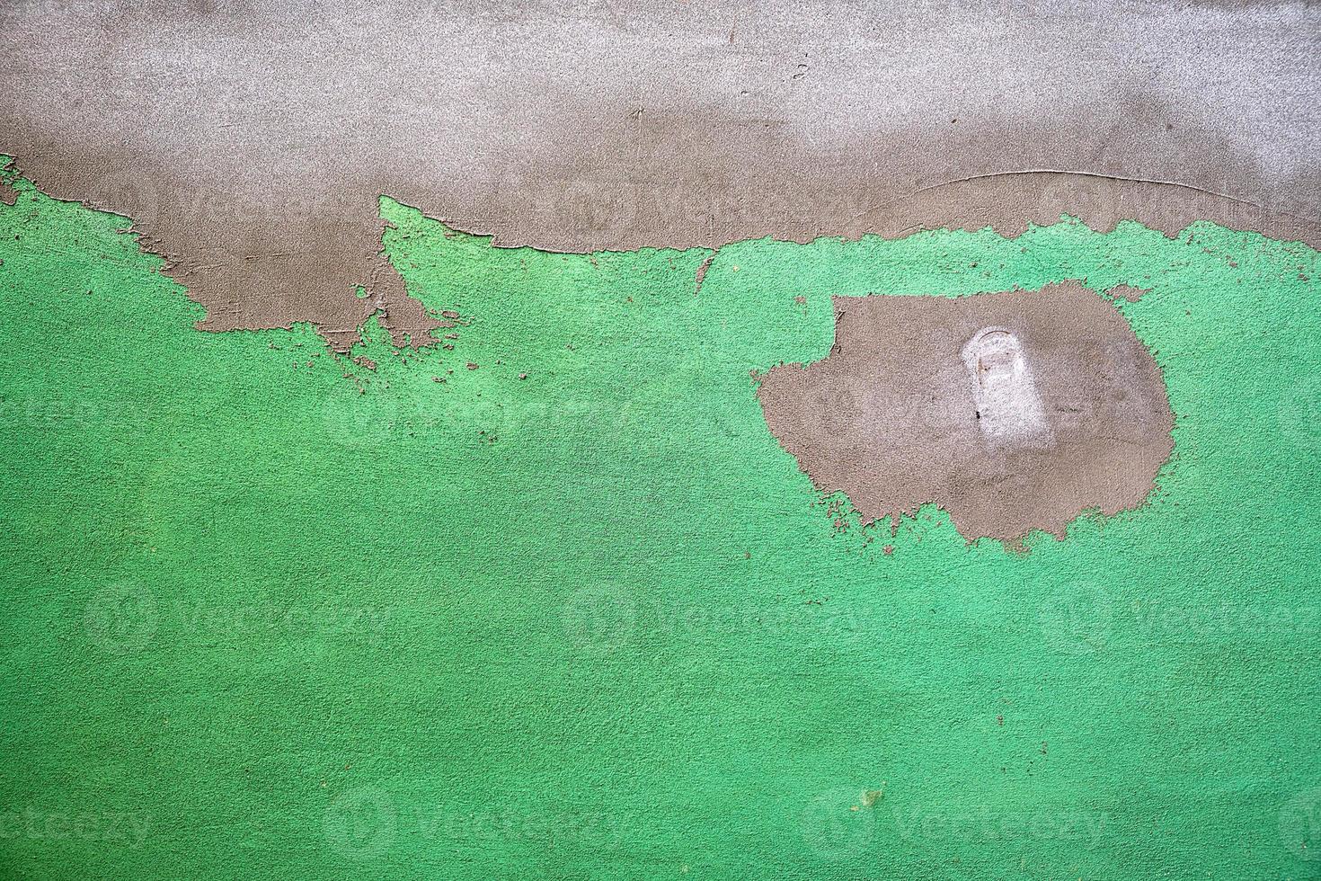 fragment of green cement wall with irregularities photo