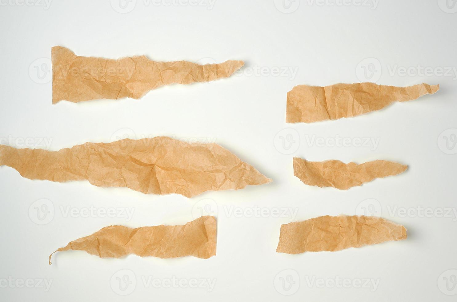 Torn crumpled brown parchment paper, white background Stock Photo