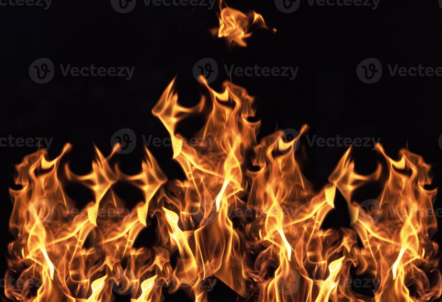 burning orange flame on black background photo