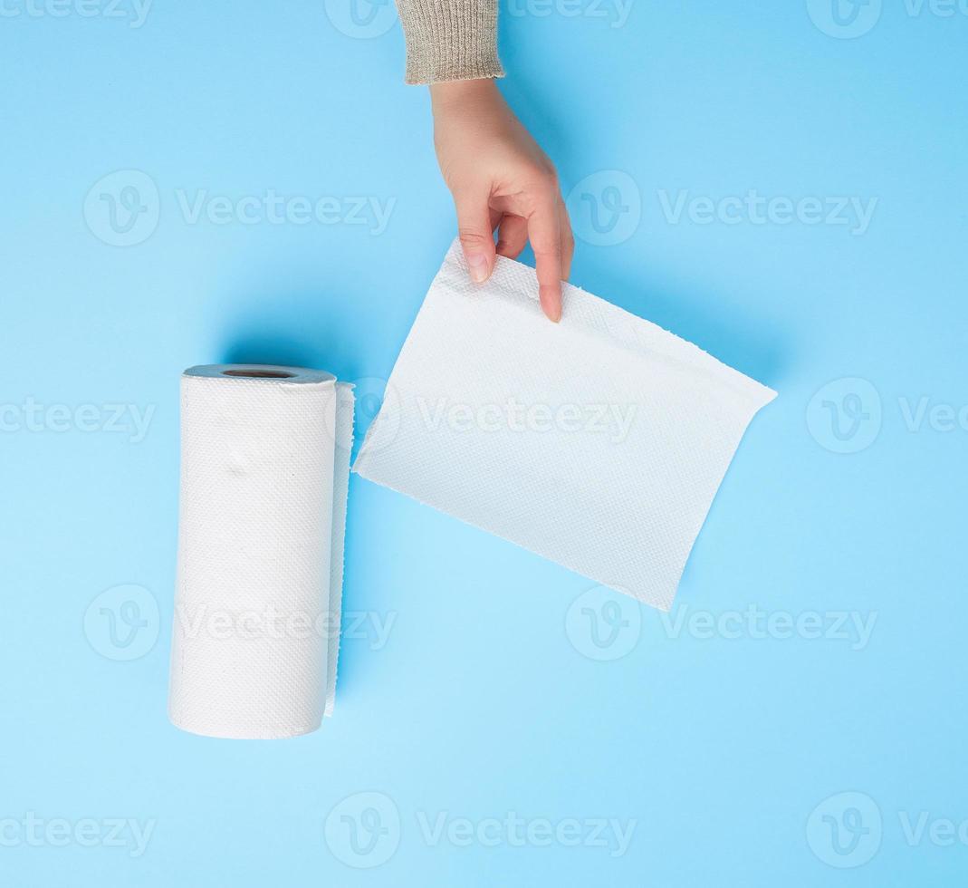 female hand holding a clean white paper napkin for face and body photo