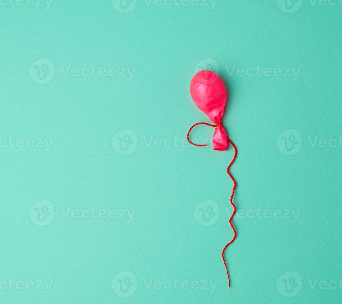 deflated rubber pink balloon photo