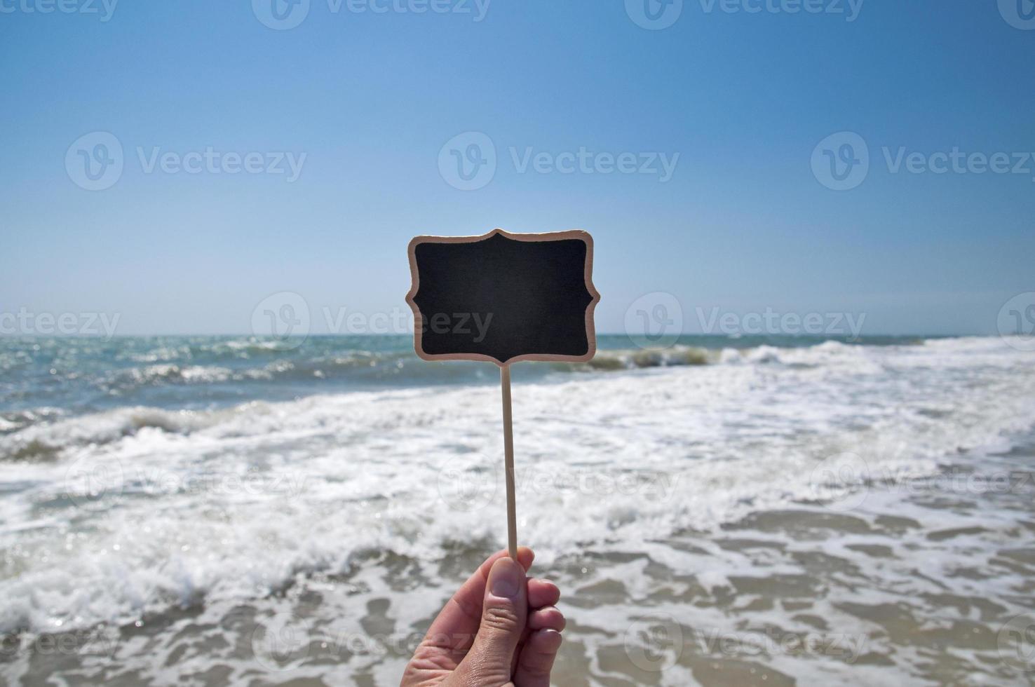 Empty wooden plaque in hand photo