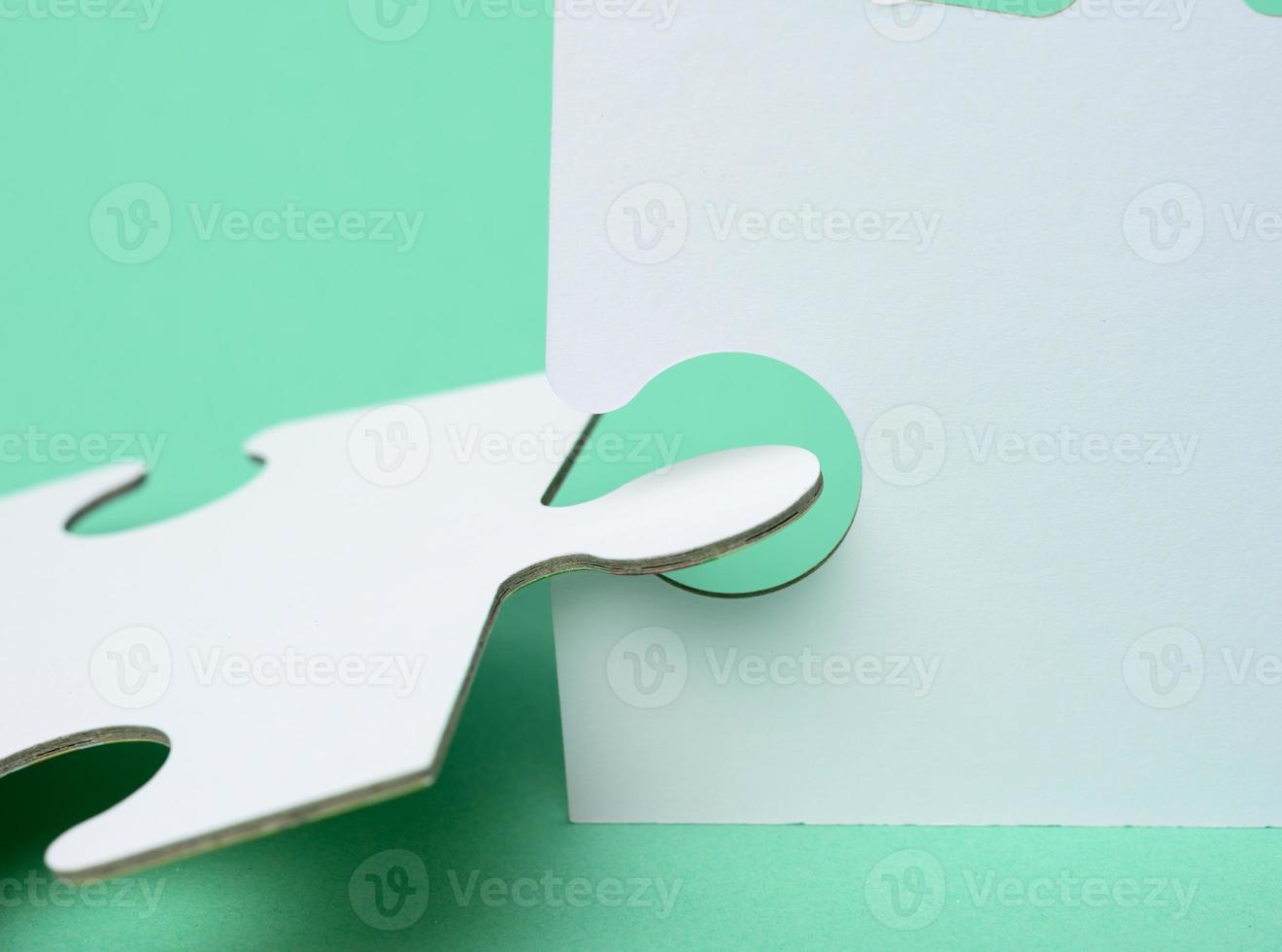 white paper puzzles on a green background, connection photo