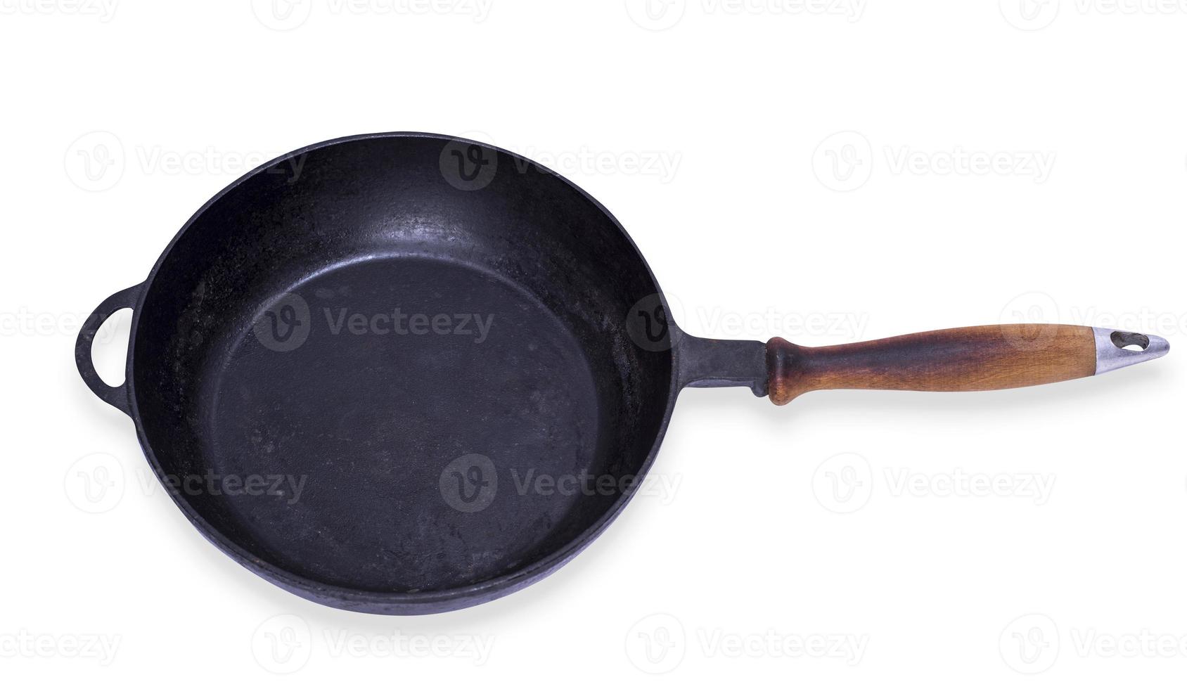 empty round cast iron frying pan with wooden handle photo