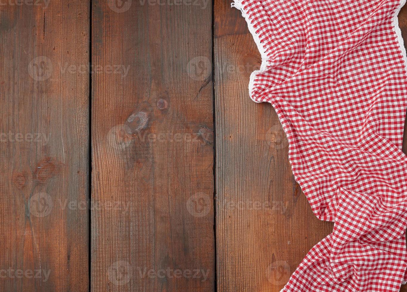 white red checkered kitchen towel on a brown wooden background photo