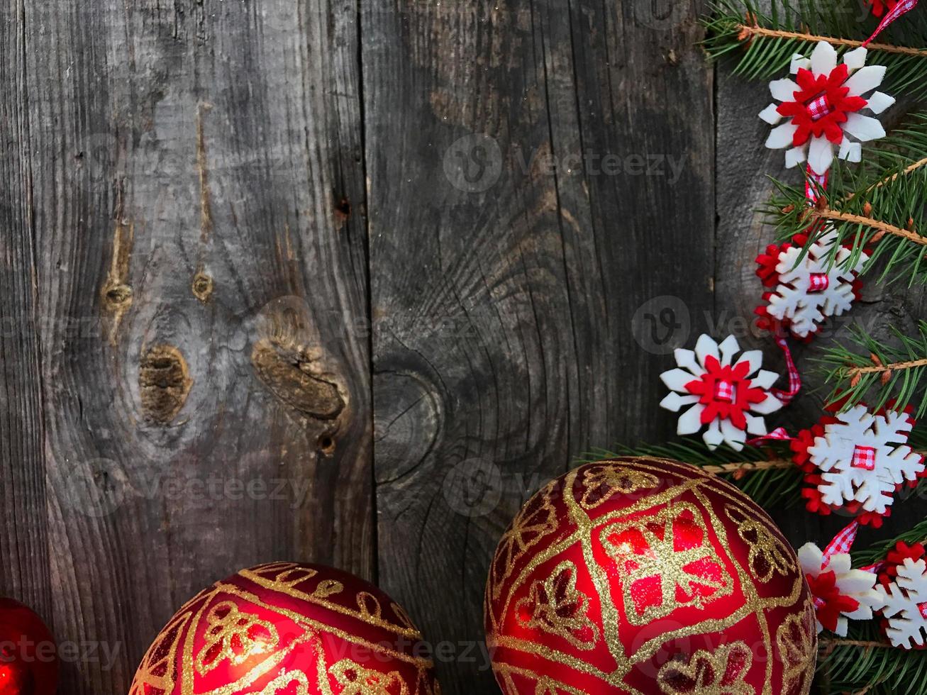 Christmas background with decorated branches of spruce and red glass balls photo