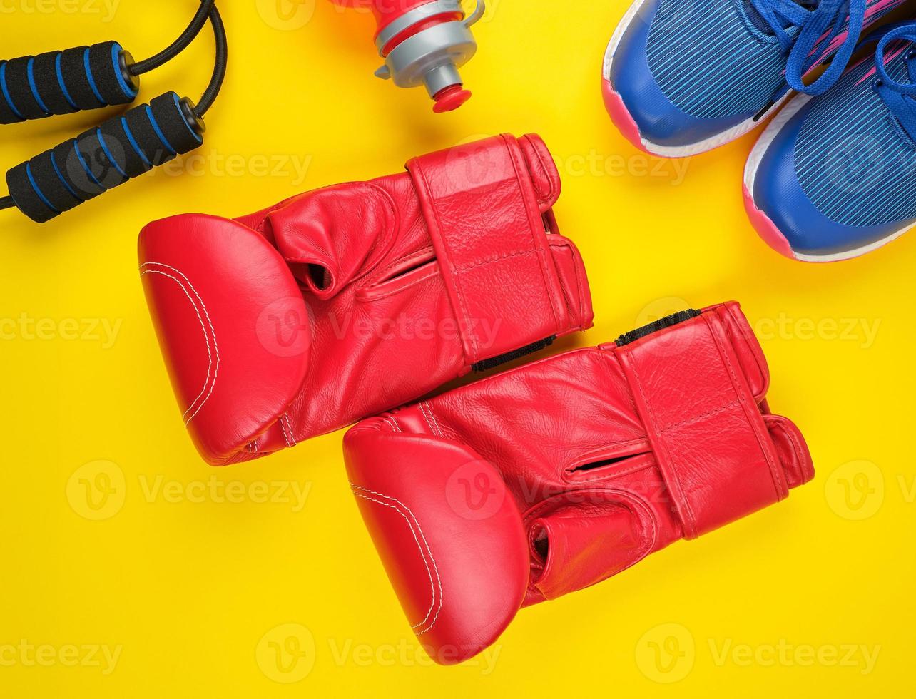 pair of red boxing gloves and blue sneakers photo