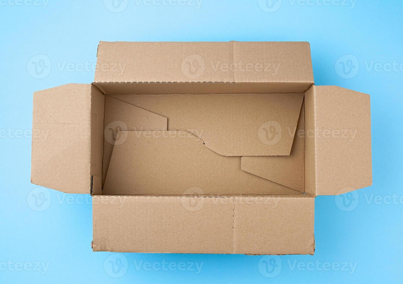 open empty square brown cardboard box for transportation and packaging of goods photo