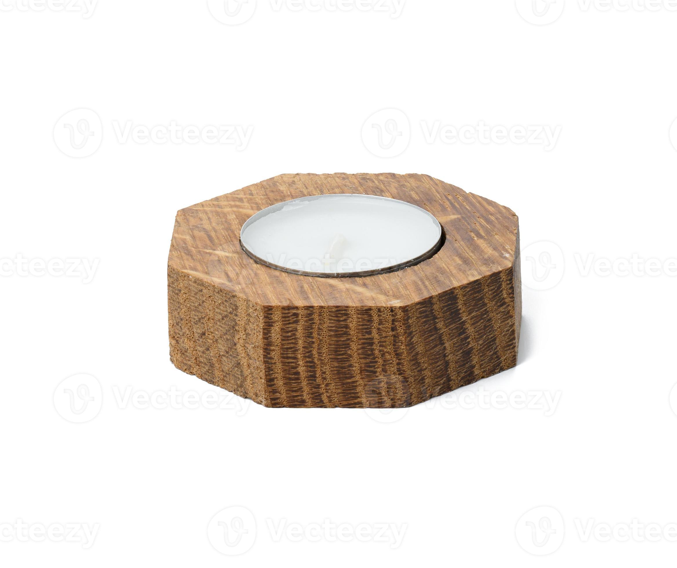 round white candle in a wooden candlestick on a white isolated