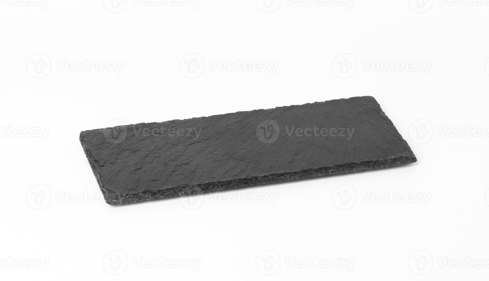 rectangular black slate stone board isolated on white background, utensils for serving food photo