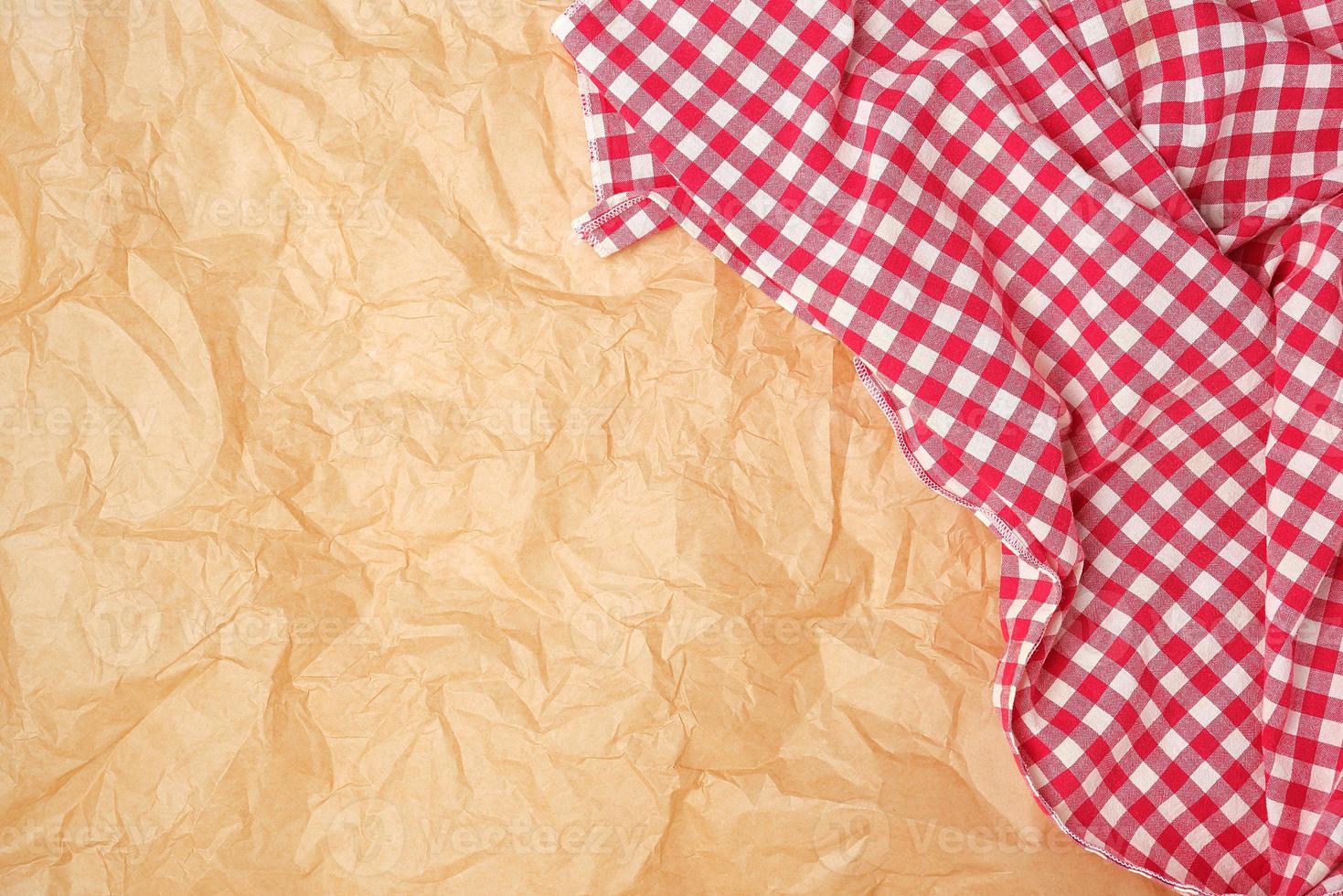 white red checkered kitchen towel on a brown paper background photo