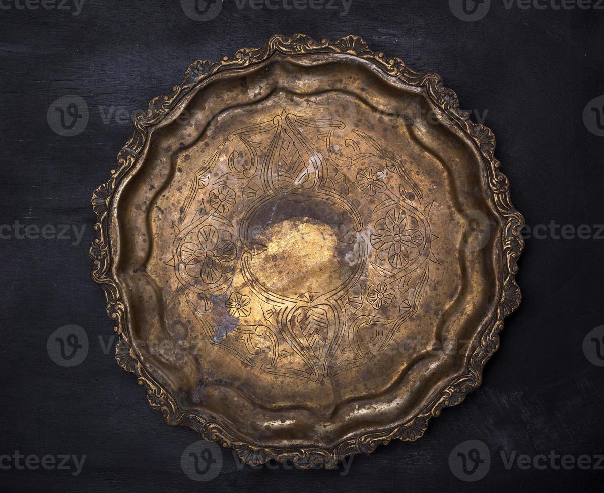 empty round copper plate with monograms photo