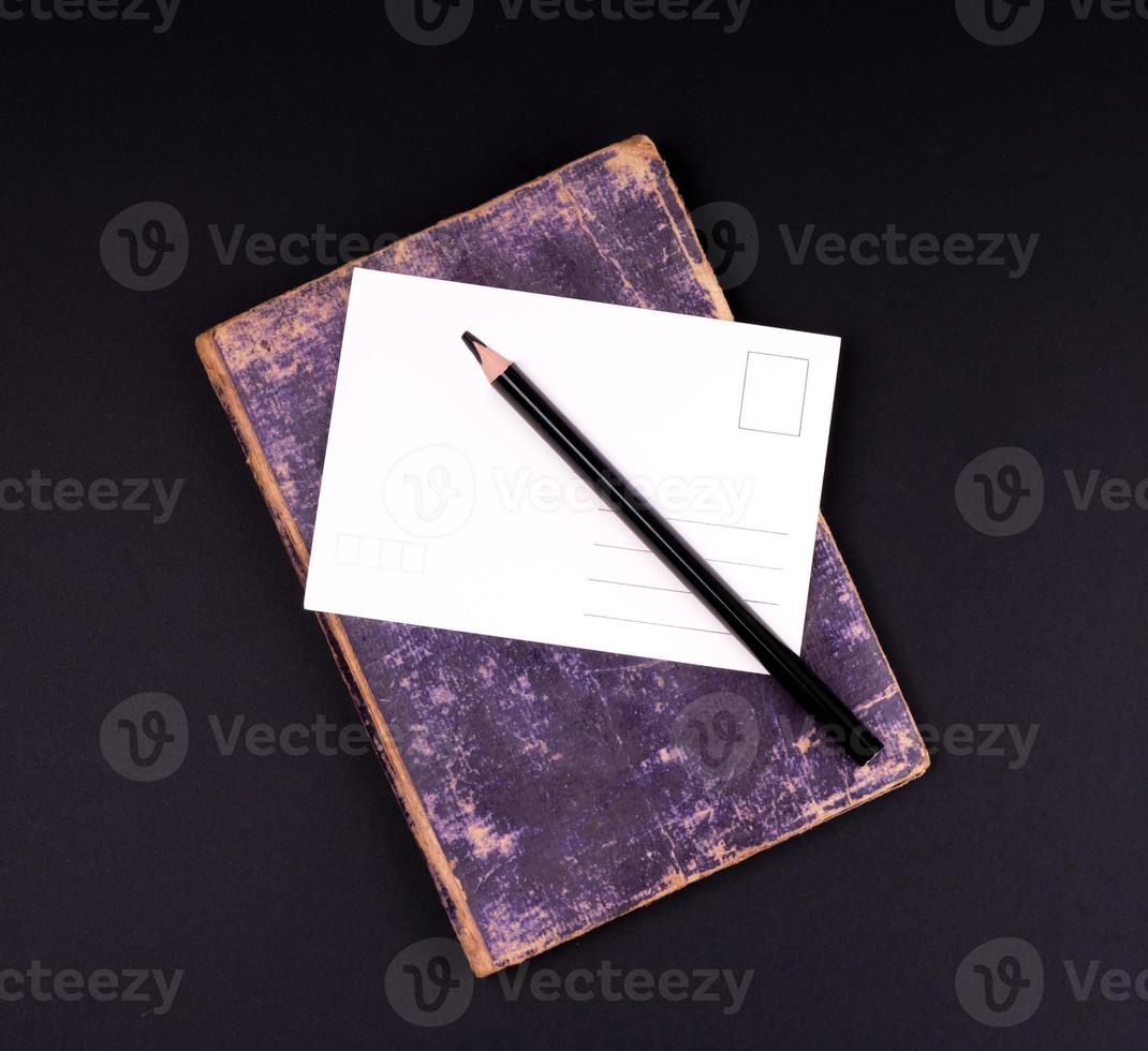 blank white paper card and black wooden pencil photo