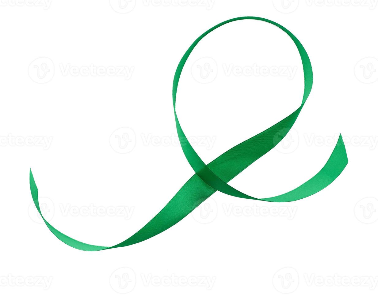 green silk ribbon in the shape of a loop isolated on white background photo