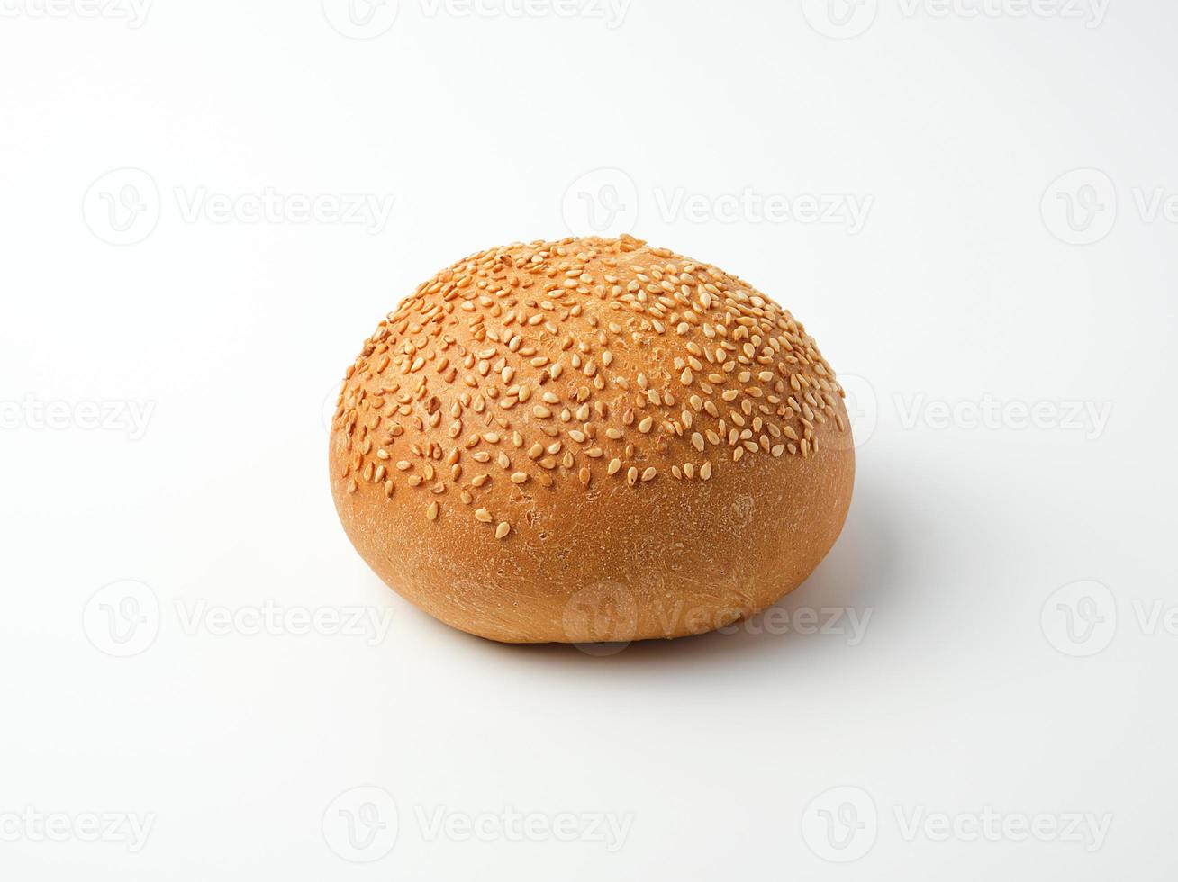 baked whole round bun with sesame seeds made from white wheat flour photo