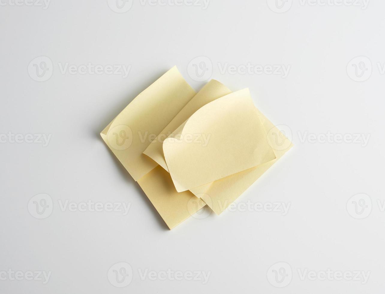 stack of yellow paper stickers on white background photo